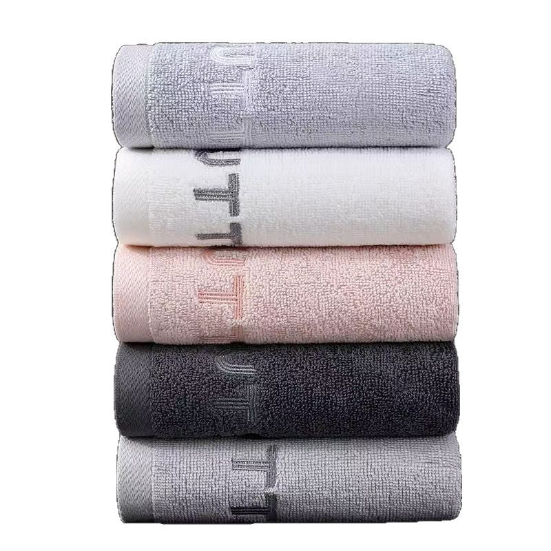Rolled cotton towel showing the plush 14 count pile and embroidered border