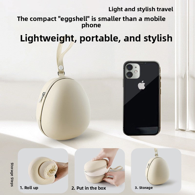 Memory foam travel neck pillow shown from the side, its U shape and toggle cinch visible