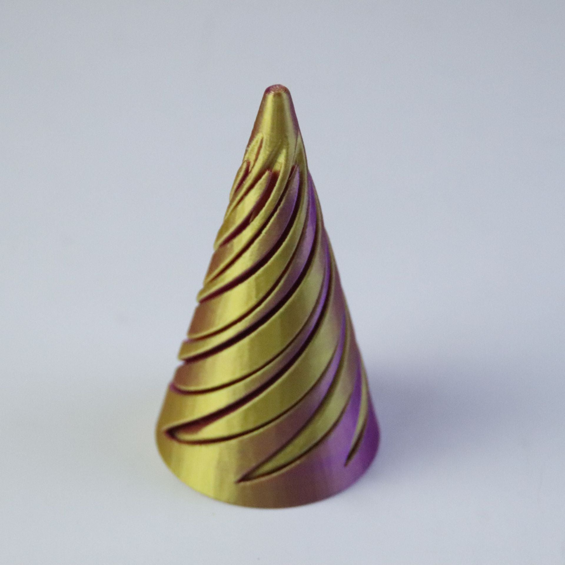 Yellow and purple gradient spiral cone with visible print layer lines along each turn