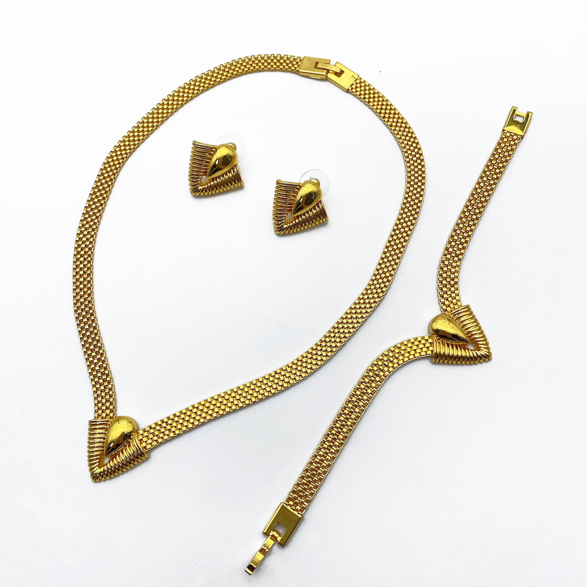 Imitation gold three-piece jewelry set worn together as a coordinated styled look