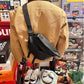 Back of the khaki zip-up jacket with brown collar and a black crossbody bag worn across the shoulder
