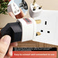 Universal to UK type G travel plug adapter shown fitted into a wall socket