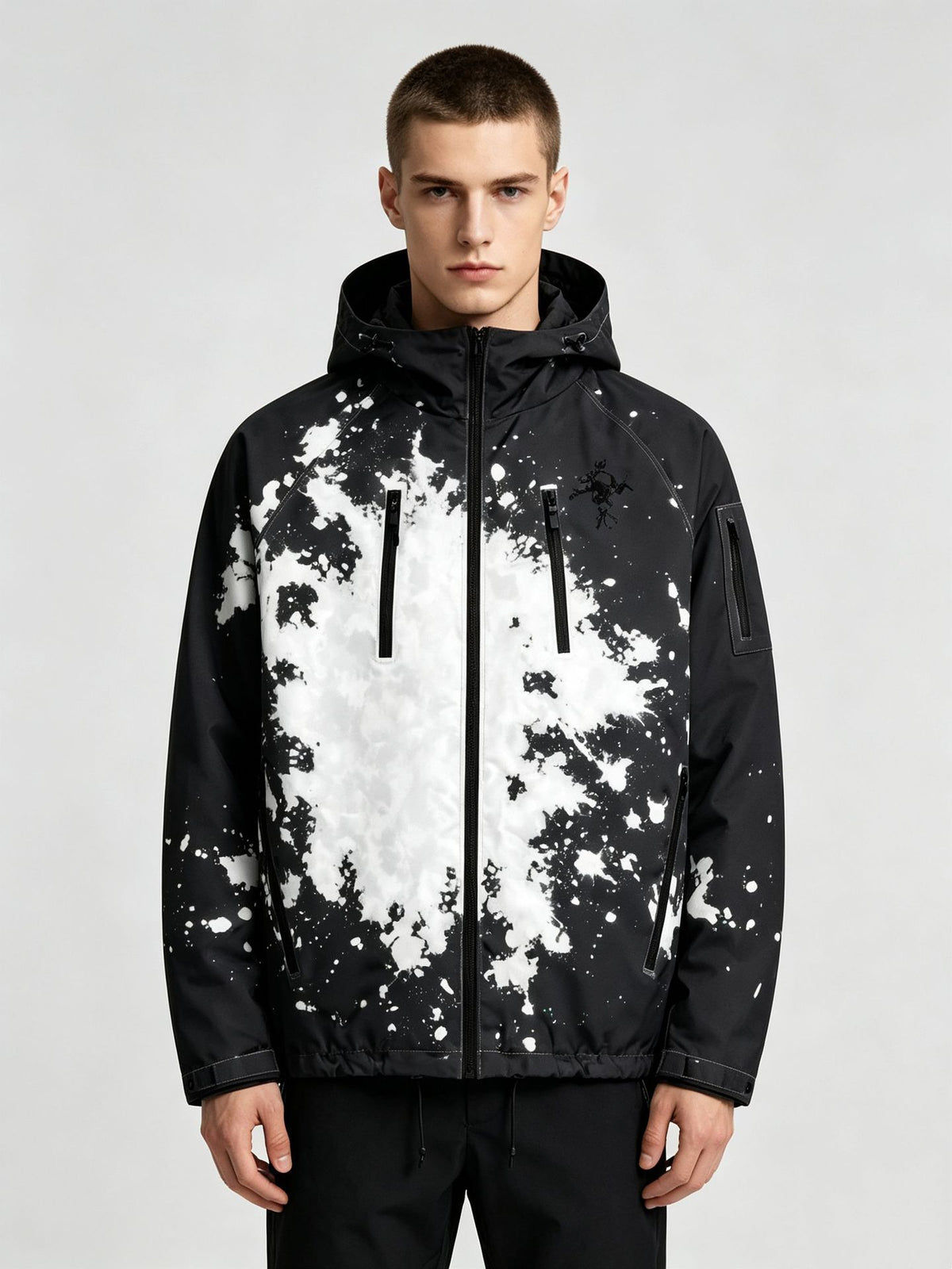 Man wearing the black hooded jacket with a white splash ink print, option photo for size M