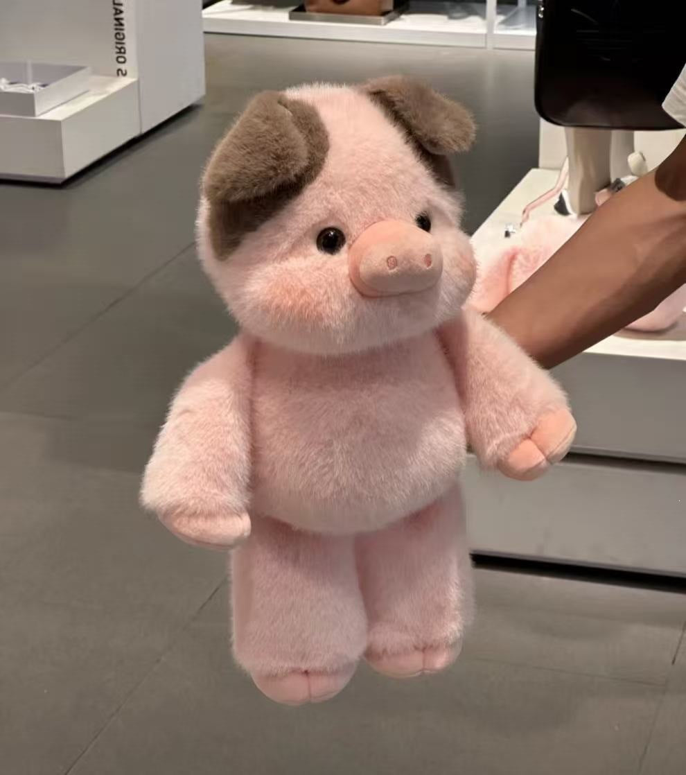 Soft plush animal toy next to a hand to show its size and scale