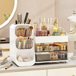 White cosmetic organizer with a brush tower, a compartment tray and two drawers holding makeup and skincare on a vanity