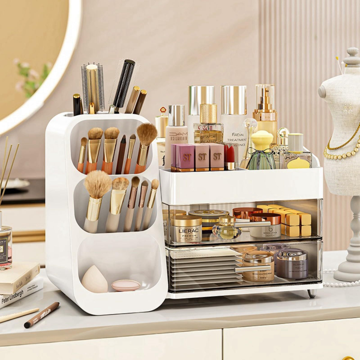 White cosmetic organizer with a brush tower, a compartment tray and two drawers holding makeup and skincare on a vanity