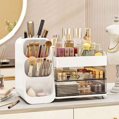 White cosmetic organizer with a brush tower, a compartment tray and two drawers holding makeup and skincare on a vanity
