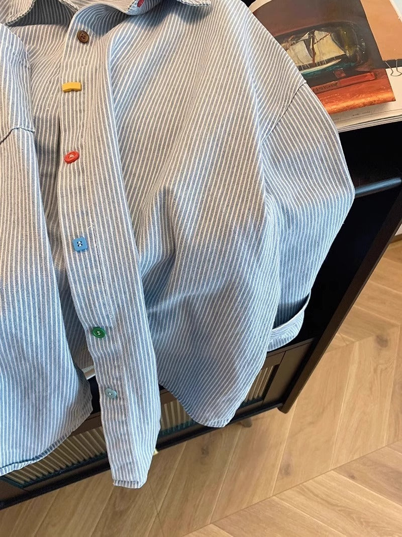 Close up of the soft cotton weave with thin blue stripes on a pale ground
