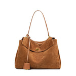 Suede leather tote bag shown with daily essentials for size reference
