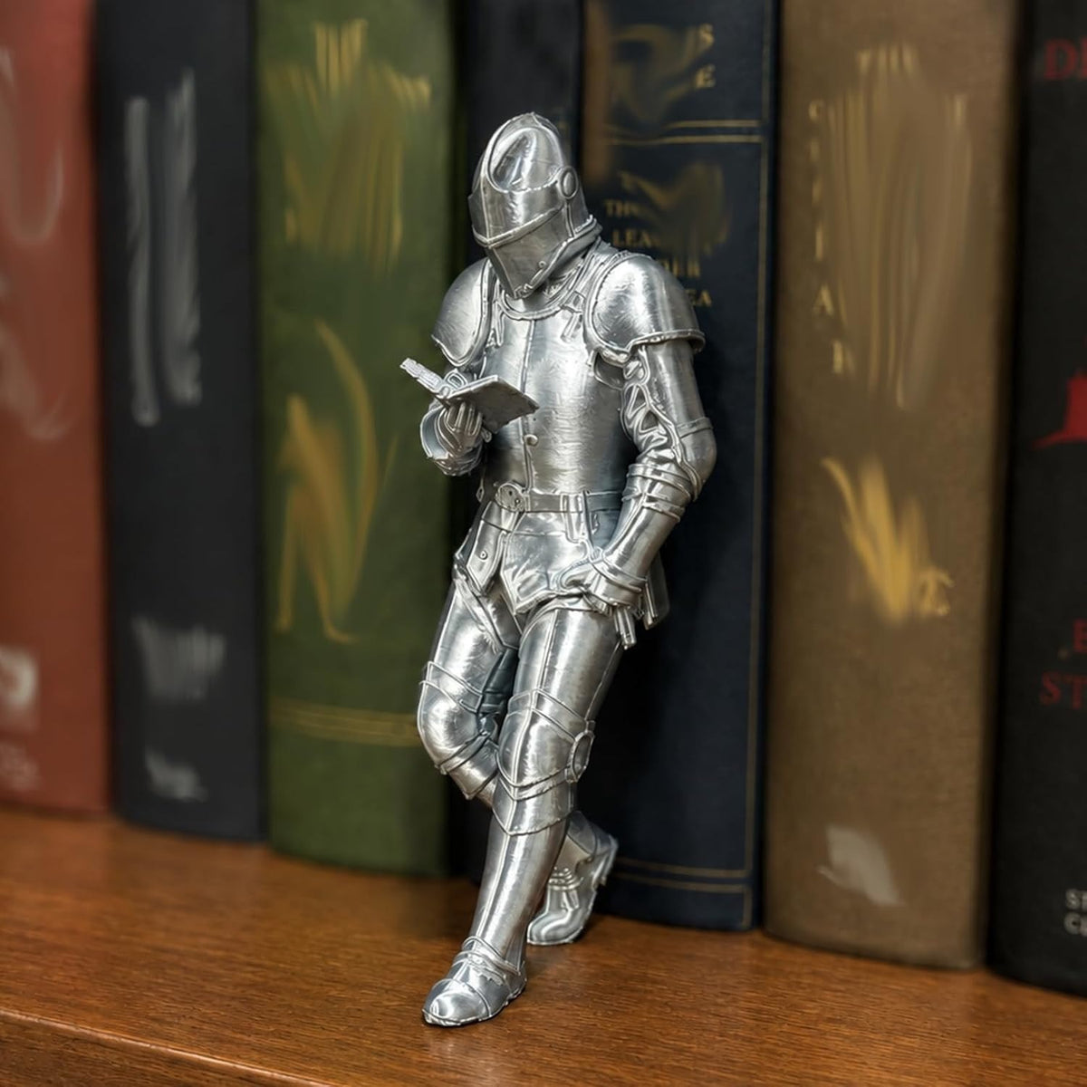 Model A silver armoured knight figurine leaning on a bookshelf and reading an open book, Silver Knight Model A option
