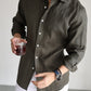 Linen long sleeve shirt worn open over a tee in a warm-weather resort lifestyle scene