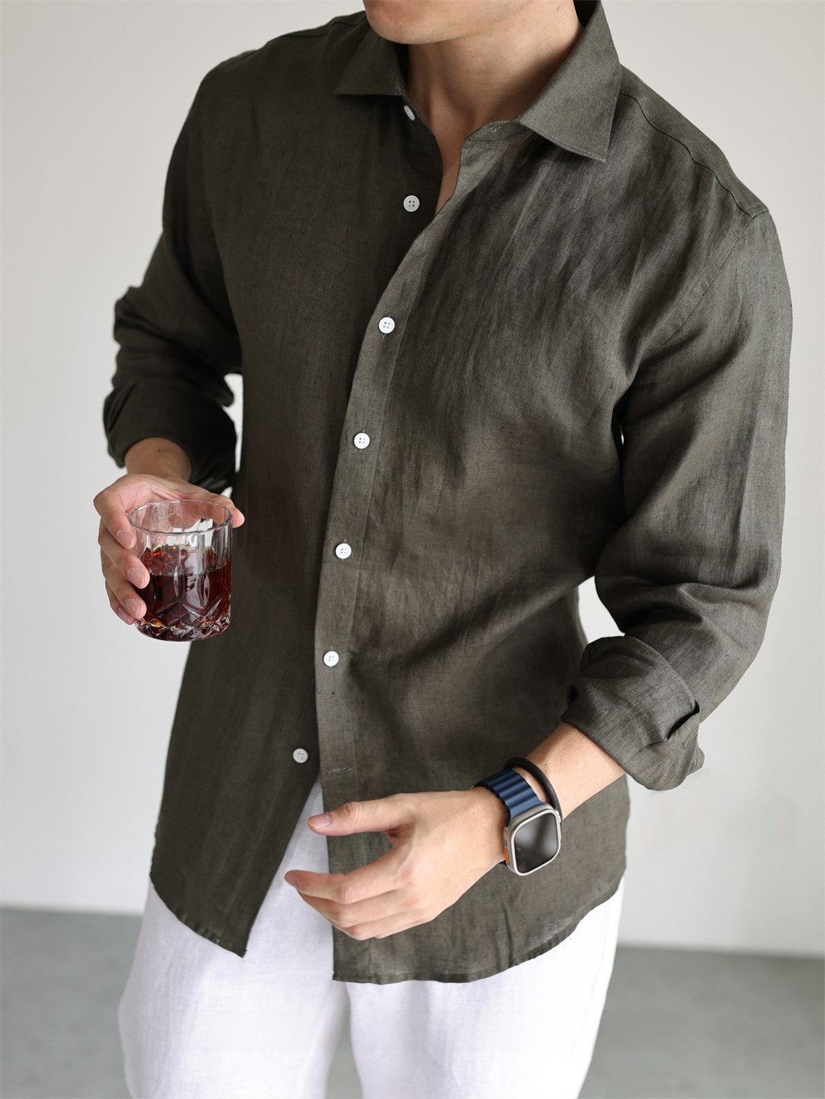 Linen long sleeve shirt worn open over a tee in a warm-weather resort lifestyle scene