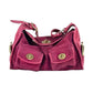 Raspberry pink suede hobo bag with two gold-tone twist lock front pockets and a buckled strap on white