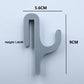 Gray resin single hook with size marks, 5.6 cm wide and 9 cm tall, seen from the front on a light background