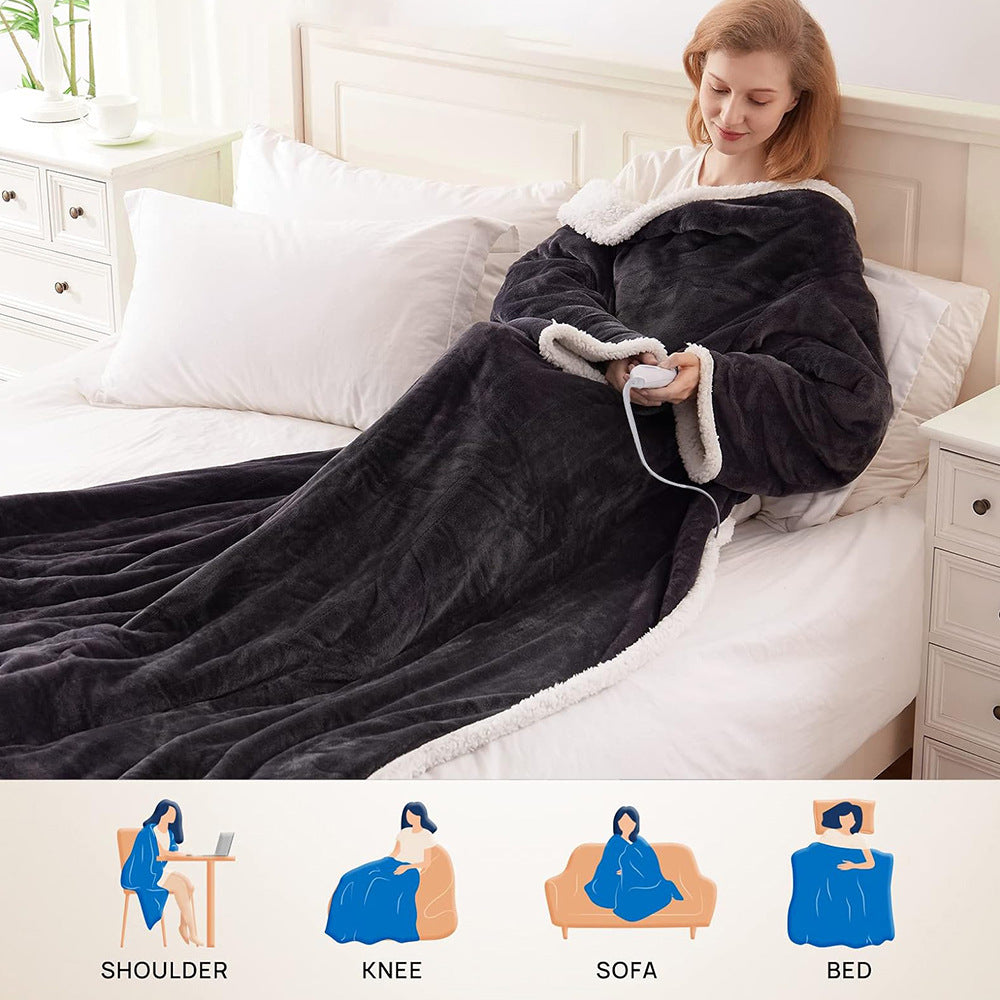 Woman reading in bed in a dark gray wearable electric blanket with sleeves, controller in hand, with usage icons