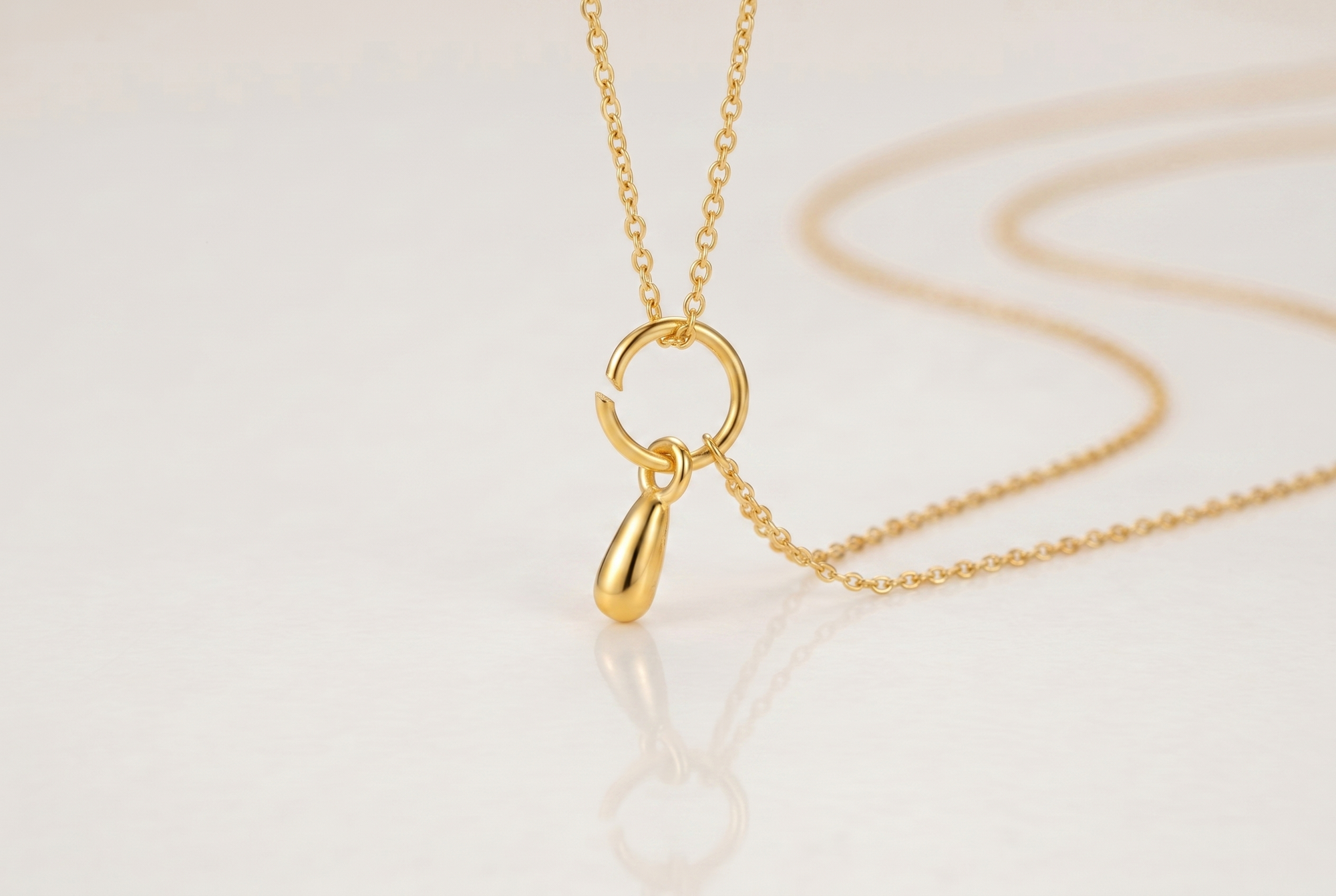 Crooked pendant on a worn open jump ring before using a finding