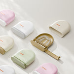 Rounded plastic retainer storage cases in pink, white, cream, and green, one open with a retainer