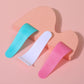Three hair removal cream scrapers with S curve edge laid flat showing the rounded blade