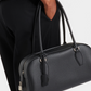 Leather shoulder handbag carried over the shoulder in use