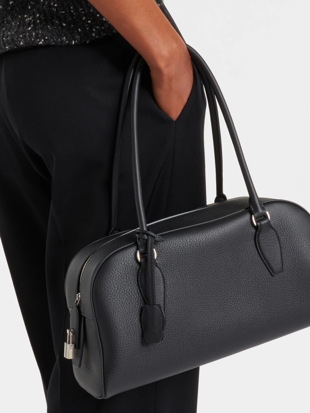 Leather shoulder handbag carried over the shoulder in use