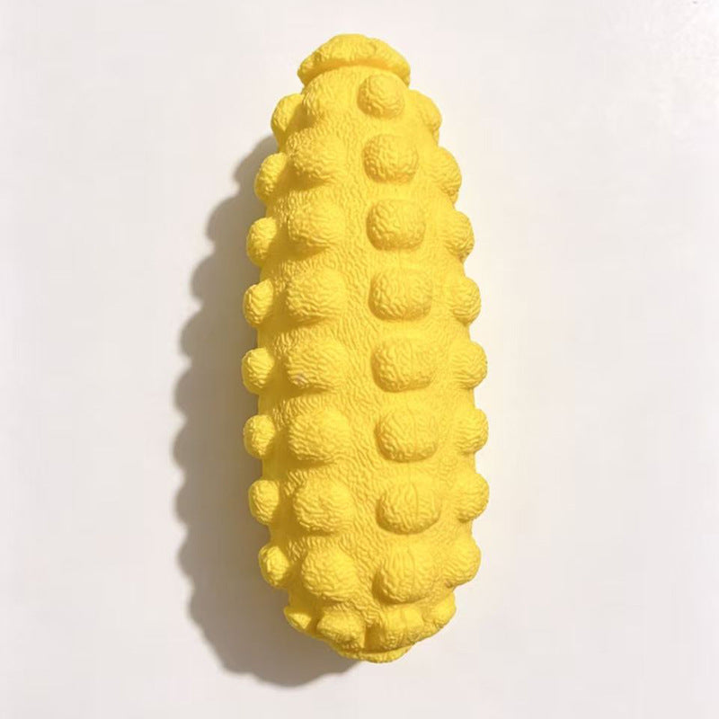 Yellow bumpy corn cob shaped dog toy on a white background, top view, option photo