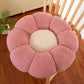 Flower shaped plush seat cushion shown on a sofa as a soft accent