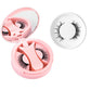 Pink round magnetic lash case open beside a fuller black magnetic lash style in a ring