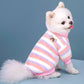 Plush fleece dog sweater laid flat showing the front leg openings and collar