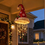 Red Christmas hat pendant light with a plush white brim, a ring of lights and hanging charms on a front porch