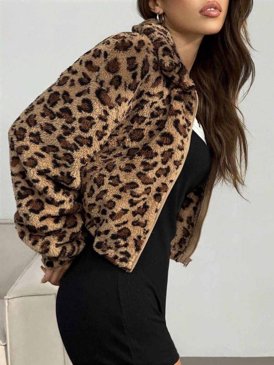 Side view of a cropped leopard vegan fur zip jacket with long sleeves on a studio model