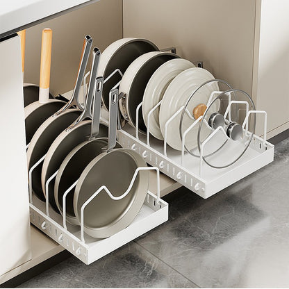 White carbon steel pot rack holding pans, lids and plates upright inside a kitchen cabinet
