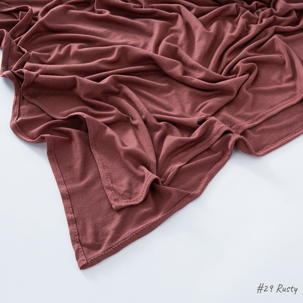 Flat lay of the soft modal cotton scarf wrap showing the even weave and finished border edge
