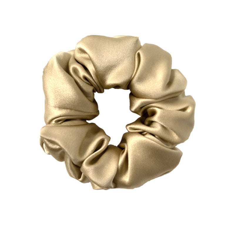 Matcha green satin scrunchie gathered into a full loop
