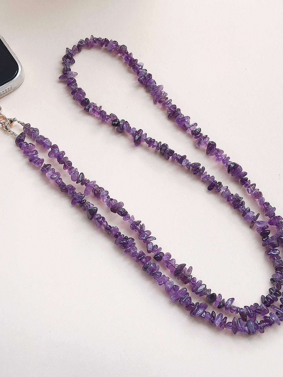 Front view of the purple chip-bead phone strap with its metal clip and tab