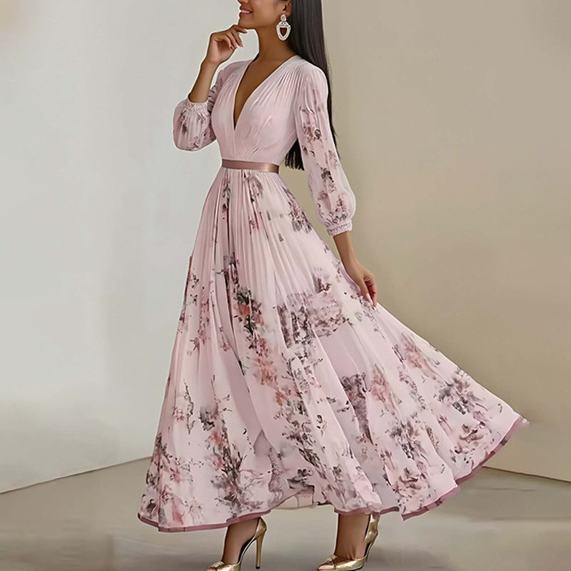 Floral print pleated maxi dress worn with heels and a top handle bag front view