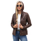 Woman wearing a coffee brown PU leather jacket with the hood up over a white top and jeans