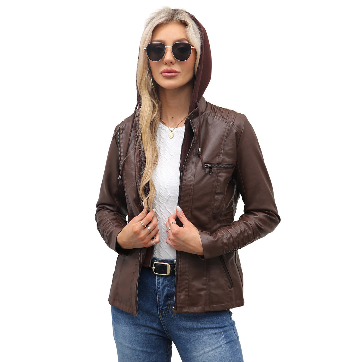 Woman wearing a coffee brown PU leather jacket with the hood up over a white top and jeans
