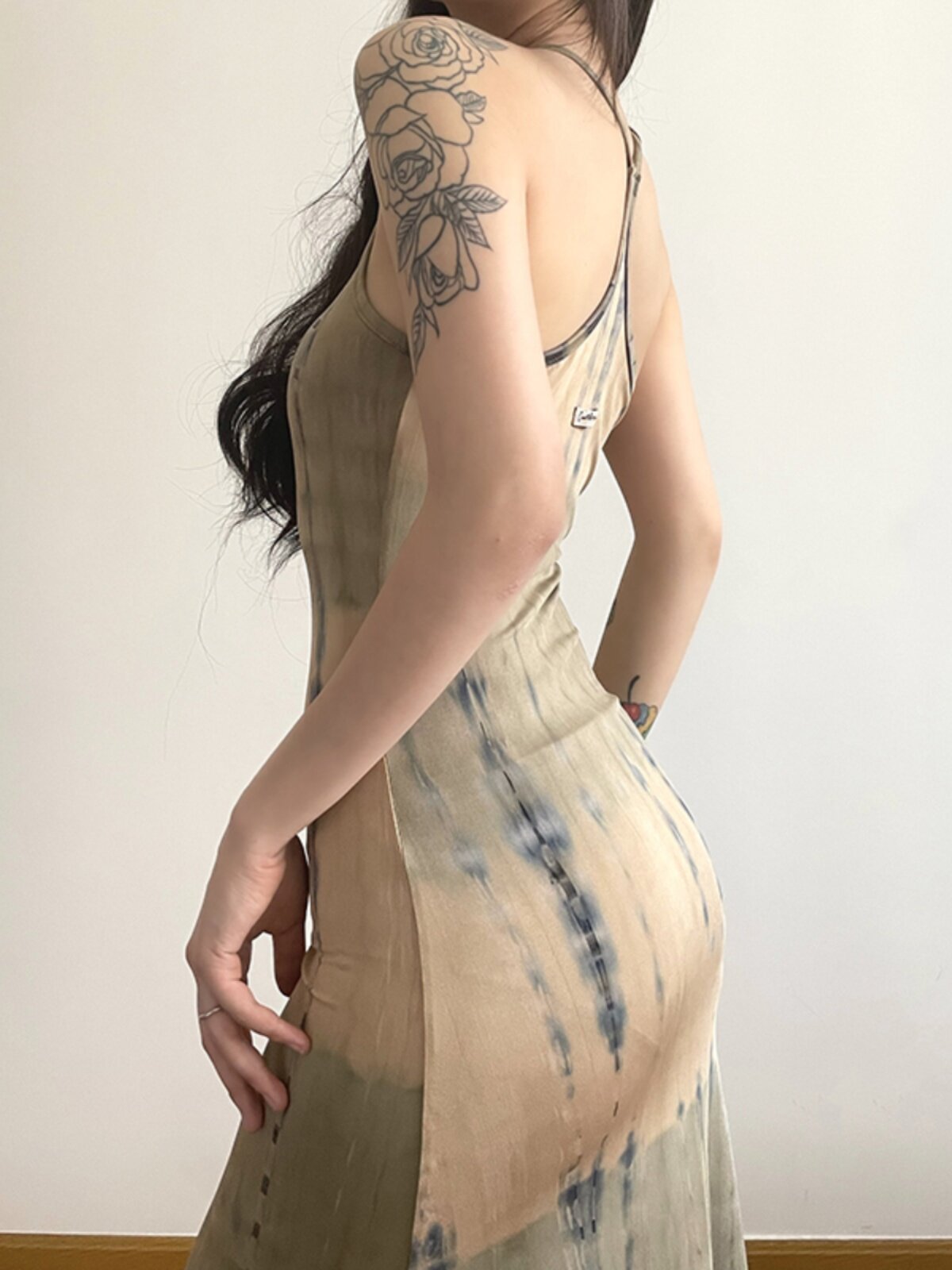 Side angle of the khaki women's dress showing its gentle draping fit