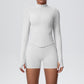 Back view of the fitted seamless zip jacket and high waist shorts set