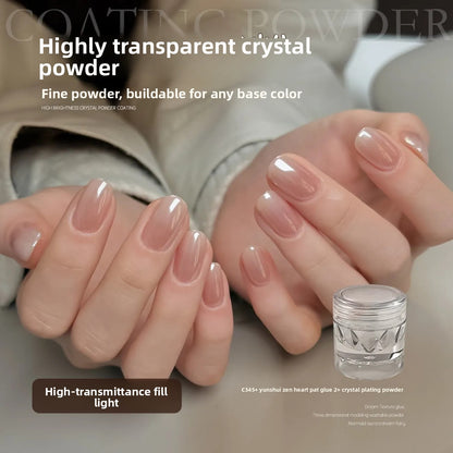 Glossy nude manicured nails beside a small clear jar of transparent crystal nail powder