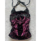 Black and pink halter top with pink wing print, rhinestone lettering and lace shoulders on a fluffy white rug