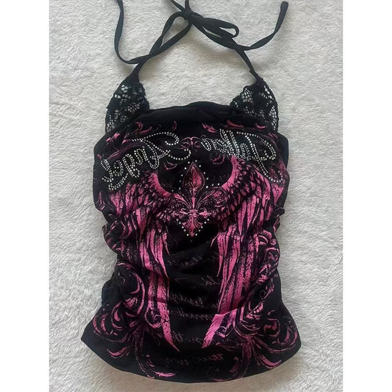 Black and pink halter top with pink wing print, rhinestone lettering and lace shoulders on a fluffy white rug