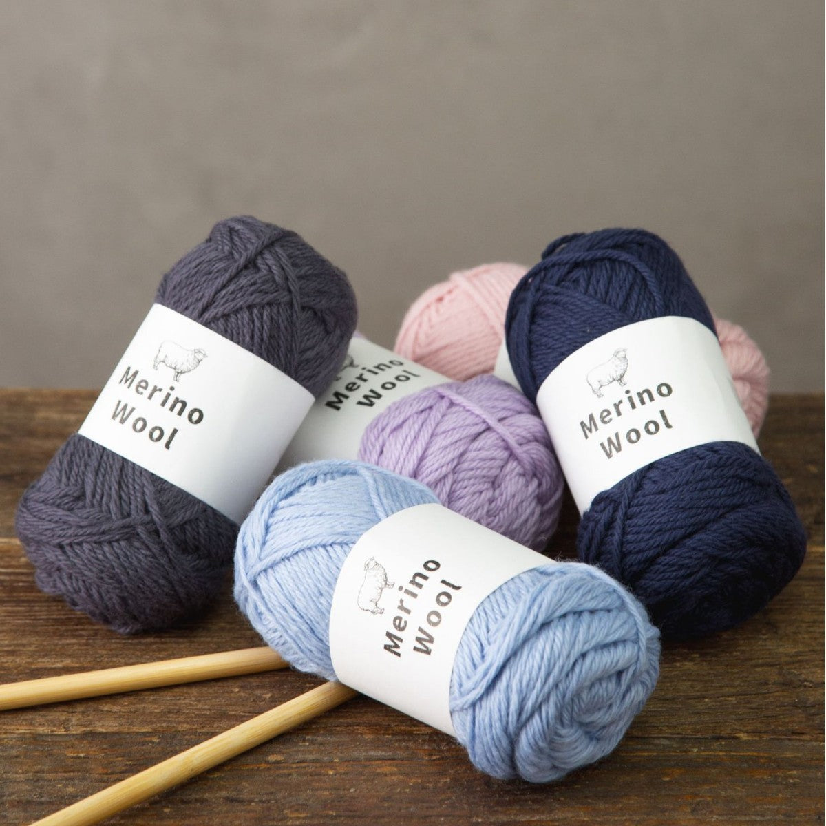 Light blue merino wool knitting yarn ball with a sheep logo band