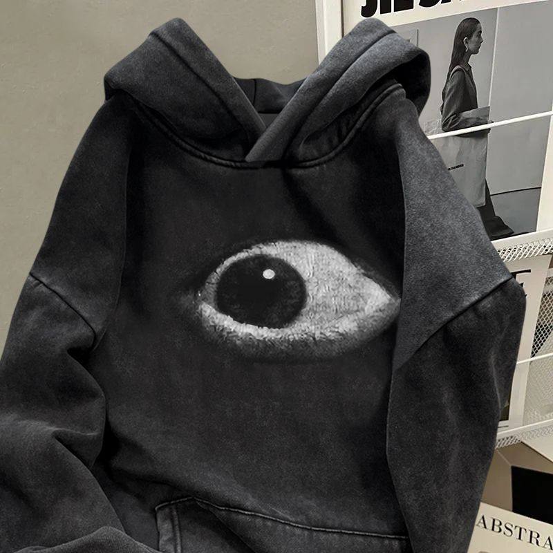 Close up of the oversized eye graphic on the chest of the washed black hoodie