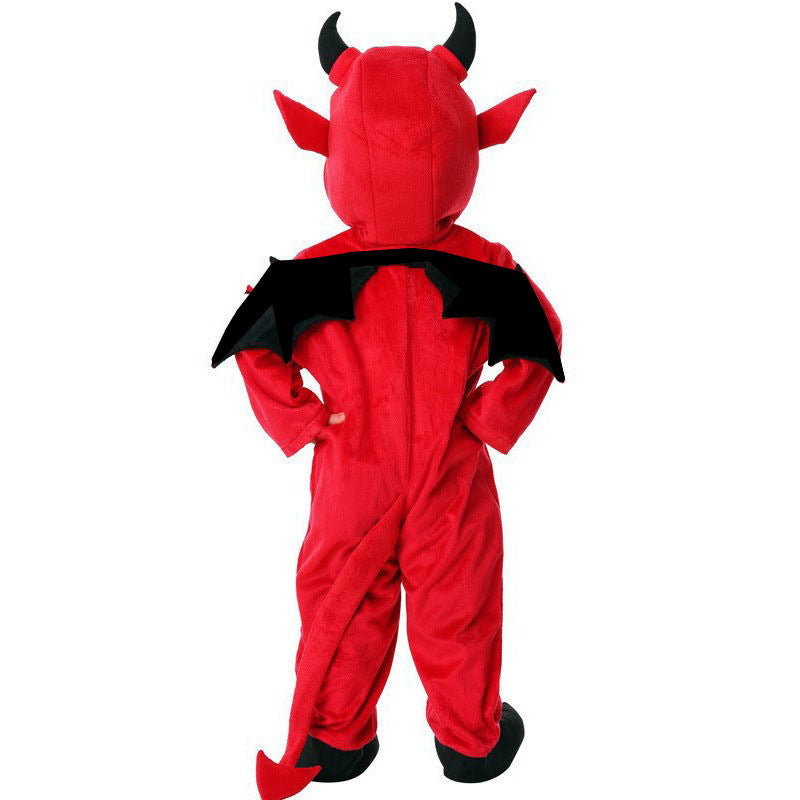 Back of a child in the red devil costume showing black bat wings, red tail and black foot covers