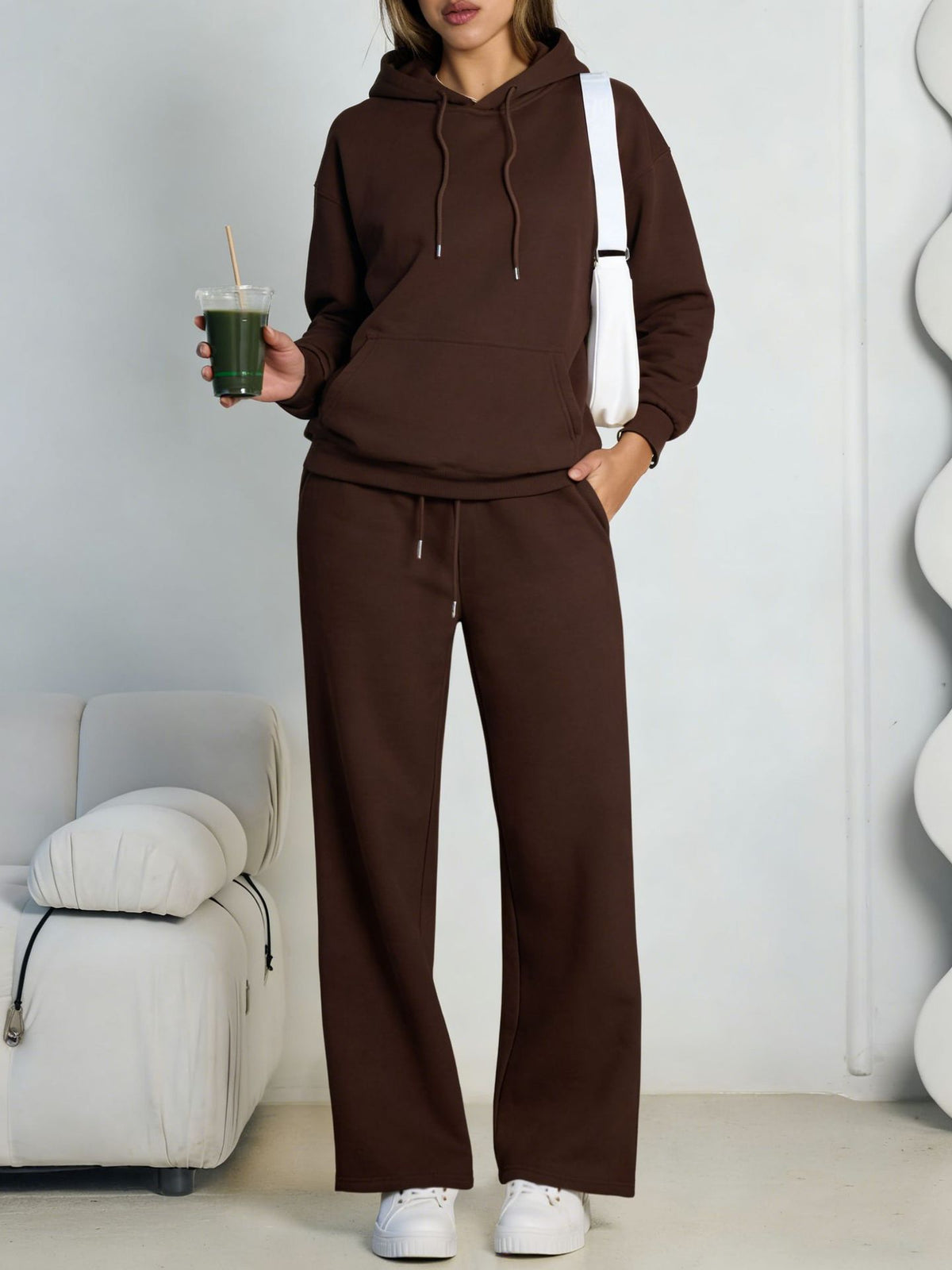 Brown fleece hooded sweatshirt and wide-leg sweatpants set worn by a model