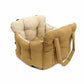 Padded car seat pet bed with raised bolster walls, carry handles and an inner clip the larger size shown on a bench seat