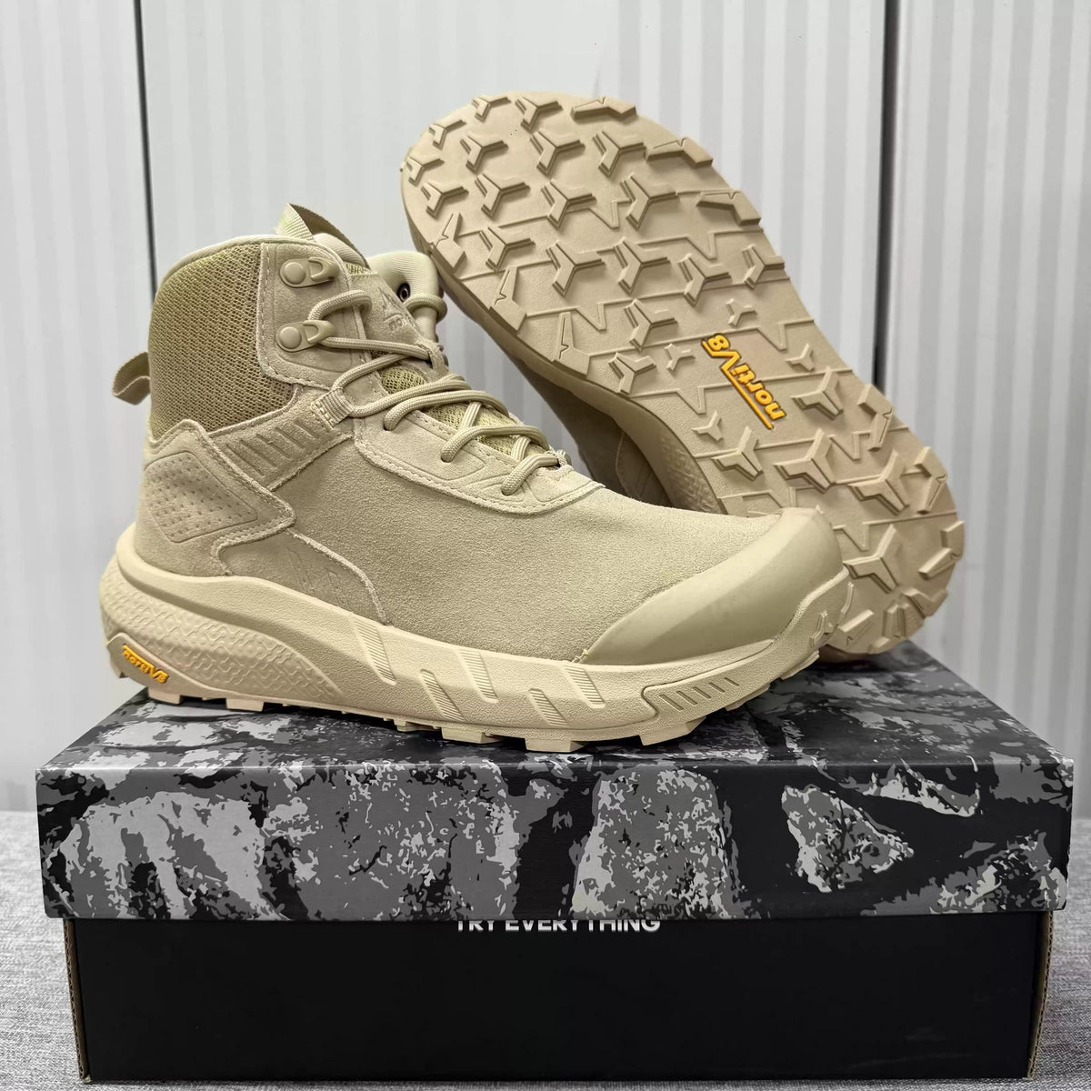 Men's mid-top hiking boots worn on a foot outdoors