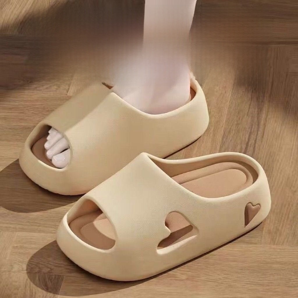 EVA heart cutout slide sandals shown from the side on a wood floor