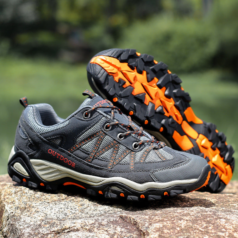 Side view of a suede and mesh lace-up hiking shoe showing the moulded toe cap